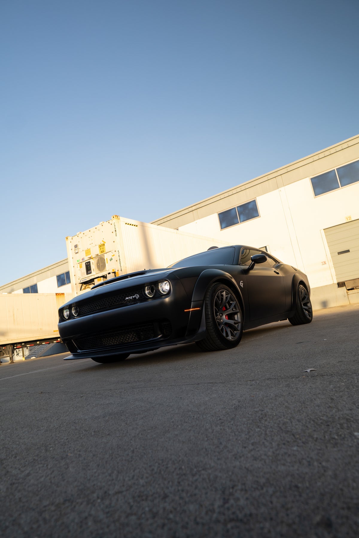 Matte black widebody Dodge Challenger Hellcat, front three quarter view